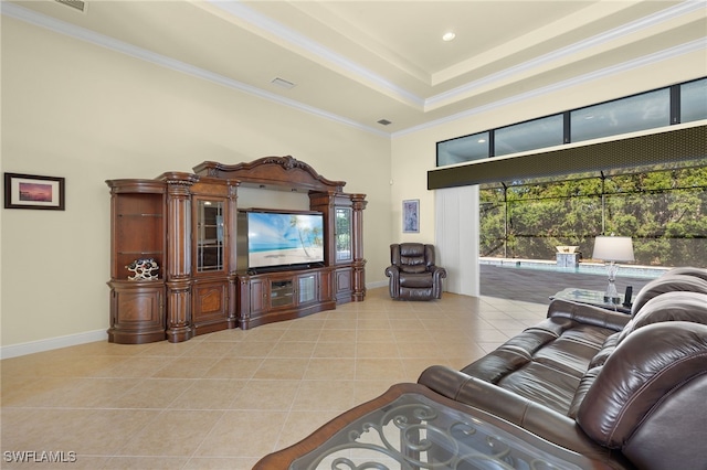 tiled living room with a towering ceiling, a raised ceiling, and crown molding