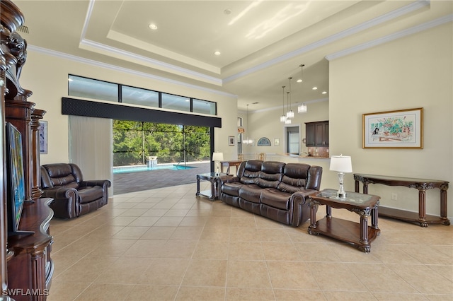 tiled living room featuring crown molding and a tray ceiling