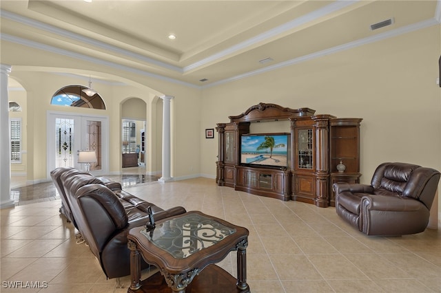 living room featuring french doors, light tile patterned floors, and decorative columns