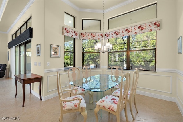 tiled dining room featuring crown molding and an inviting chandelier