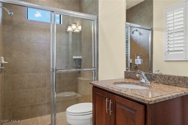 bathroom featuring walk in shower, vanity, and toilet