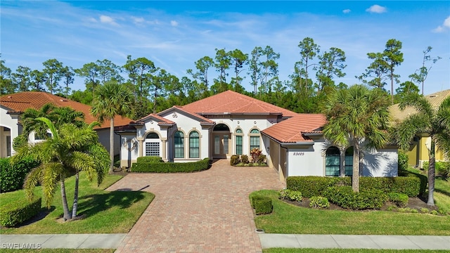 mediterranean / spanish-style house with a front lawn