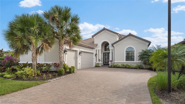 mediterranean / spanish-style home with a garage