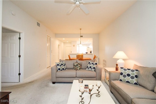 living room featuring ceiling fan and light colored carpet