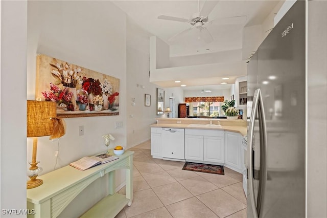 kitchen with ceiling fan, light tile patterned floors, white cabinetry, kitchen peninsula, and stainless steel appliances