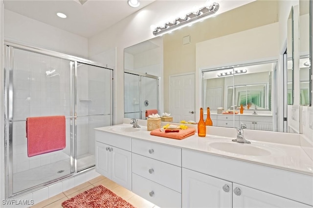 bathroom featuring tile patterned flooring, vanity, and a shower with shower door