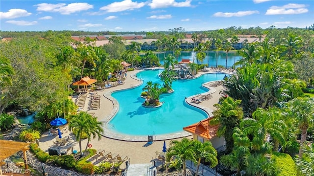 view of swimming pool featuring a patio area and a water view