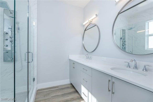 bathroom featuring vanity, hardwood / wood-style flooring, and a shower with shower door