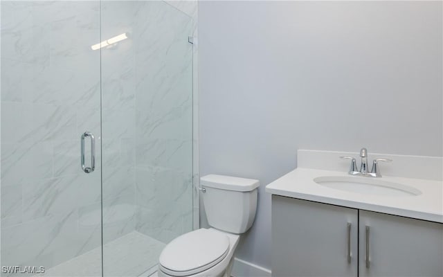 bathroom with vanity, toilet, and a shower with shower door