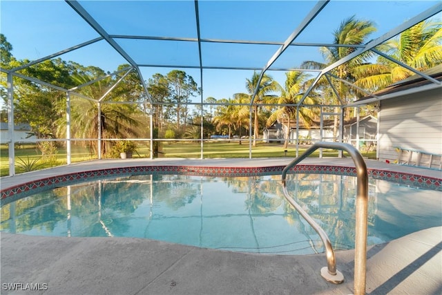 view of swimming pool featuring a lanai