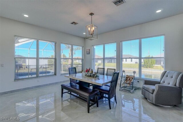 dining room with a chandelier and a healthy amount of sunlight