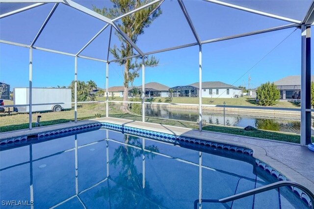 view of pool with a water view and a lanai