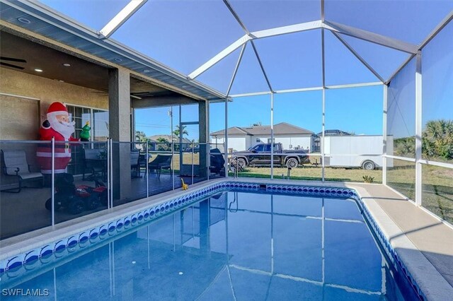 view of swimming pool featuring glass enclosure