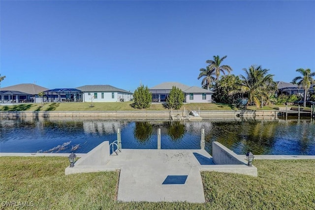 dock area featuring a water view and a yard