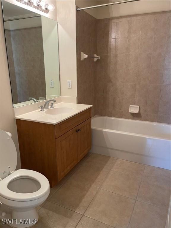 full bathroom featuring tile patterned floors, vanity, toilet, and tiled shower / bath