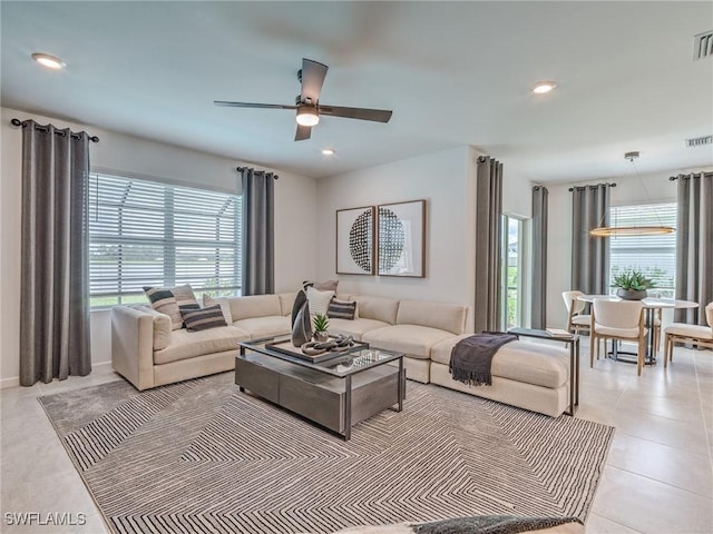 living room featuring ceiling fan and light tile patterned floors