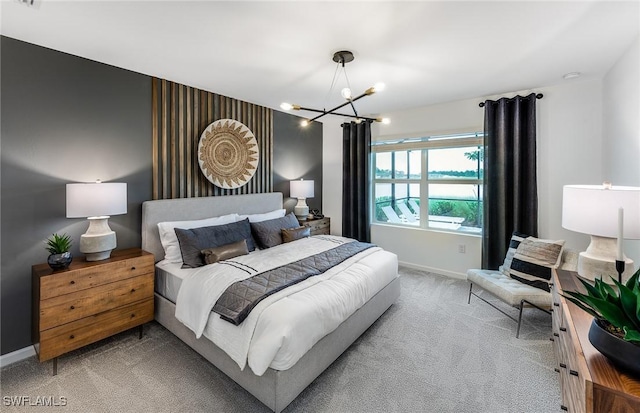 bedroom with carpet flooring and a notable chandelier