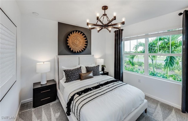 carpeted bedroom with a notable chandelier