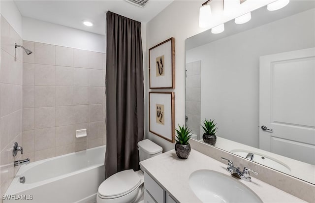 full bathroom featuring toilet, shower / bathtub combination with curtain, and vanity