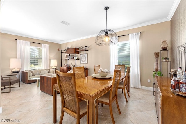 dining space with crown molding and light tile patterned floors