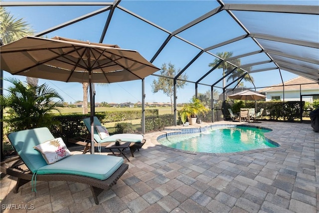 view of swimming pool with glass enclosure and a patio