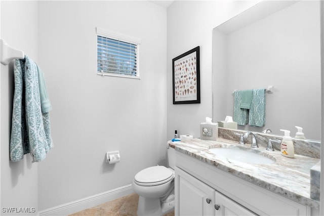 bathroom with tile patterned flooring, vanity, and toilet