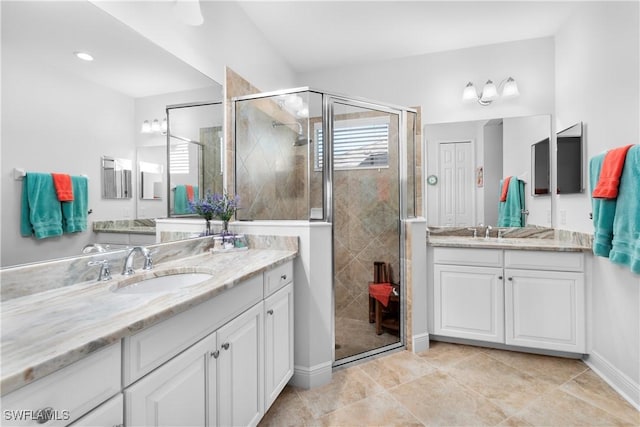 bathroom with tile patterned floors, vanity, and a shower with shower door