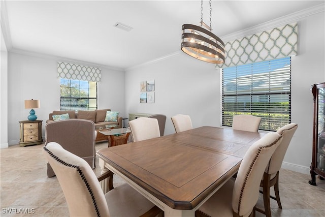 dining area with a notable chandelier, a healthy amount of sunlight, and crown molding