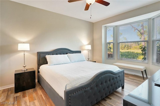 bedroom with ceiling fan and light wood-type flooring