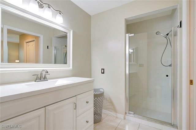 bathroom featuring vanity, tile patterned floors, and a shower with shower door