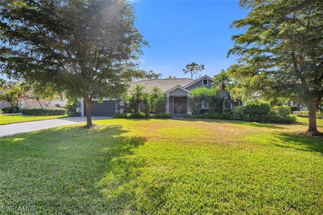 view of front of house with a front yard and a garage