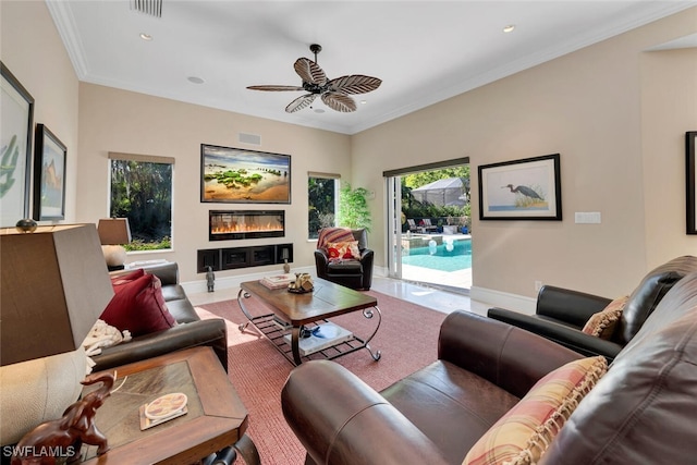 living room featuring ceiling fan and crown molding