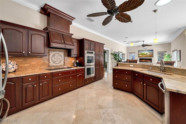 kitchen with sink, crown molding, light stone countertops, decorative light fixtures, and stainless steel appliances