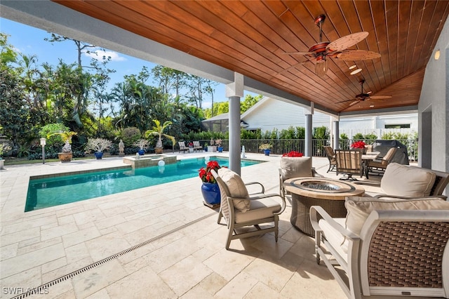 view of pool with a patio area, ceiling fan, an outdoor fire pit, and a grill