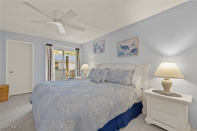 carpeted bedroom with ceiling fan, access to exterior, and a textured ceiling