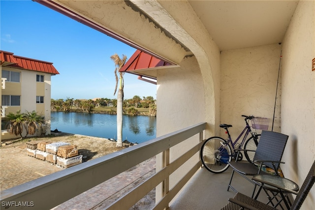 balcony featuring a water view