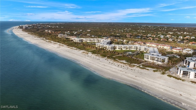 drone / aerial view with a water view and a view of the beach