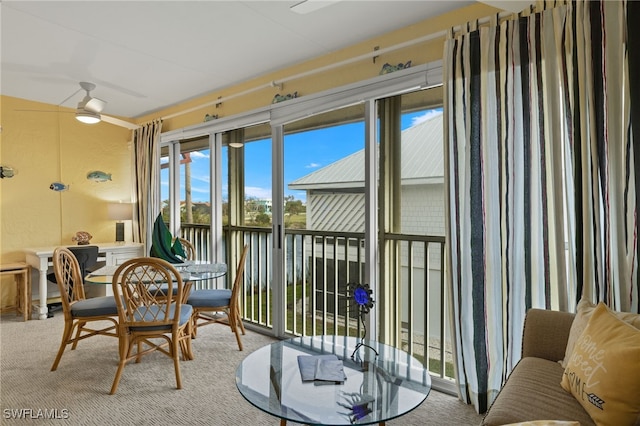 sunroom featuring ceiling fan