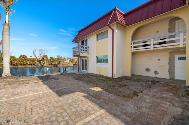 view of side of home featuring a water view