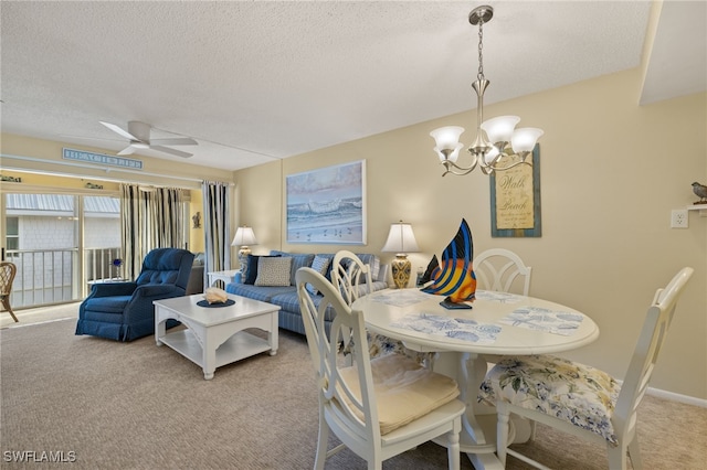 dining space with a textured ceiling, light carpet, and ceiling fan with notable chandelier