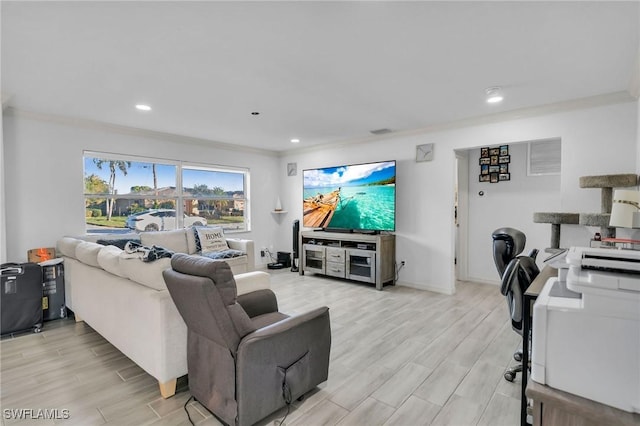 living room with light hardwood / wood-style floors and crown molding