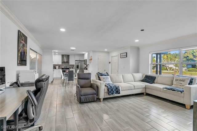 living room featuring light wood-type flooring and ornamental molding