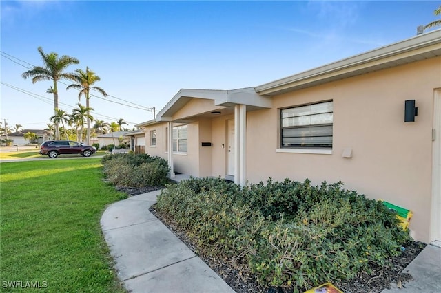 doorway to property with a yard