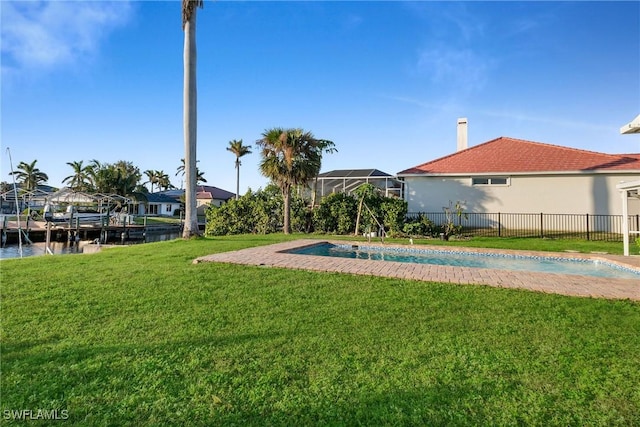 view of pool featuring a yard and a water view