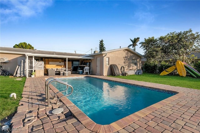 view of swimming pool featuring a lawn, an outdoor living space, and a patio