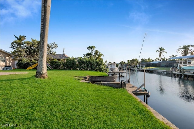 view of dock with a water view and a lawn