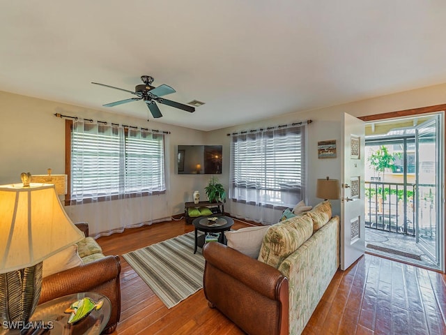 living room featuring hardwood / wood-style flooring, ceiling fan, and a wealth of natural light