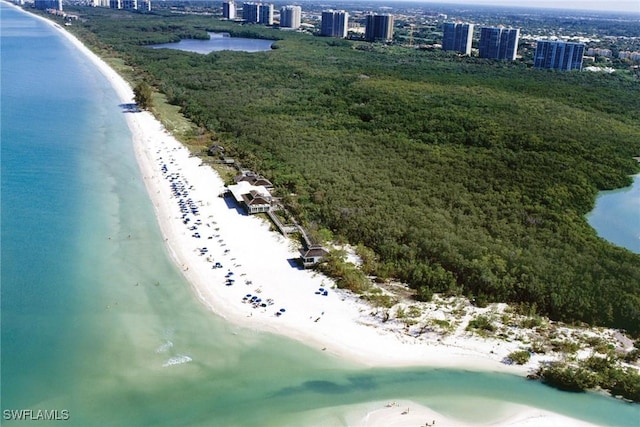 birds eye view of property with a water view and a view of the beach