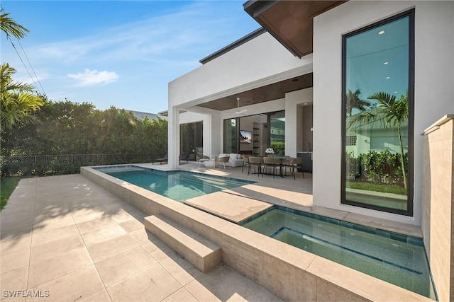 view of pool featuring an outdoor living space, a patio area, fence, a fenced in pool, and an in ground hot tub