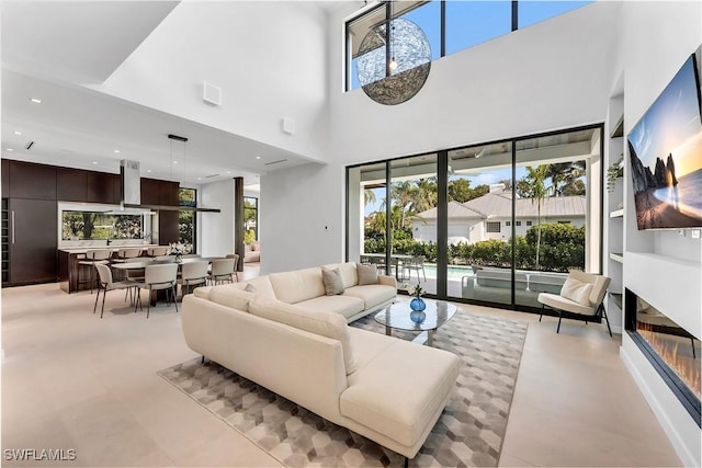 788 7th Ave N, Naples, FL 34102 - living room featuring healthy amount of natural light, a high ceiling, and recessed lighting